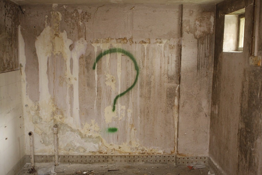 Graffiti of a large, green question mark in Old Changi Hospital in Singapore