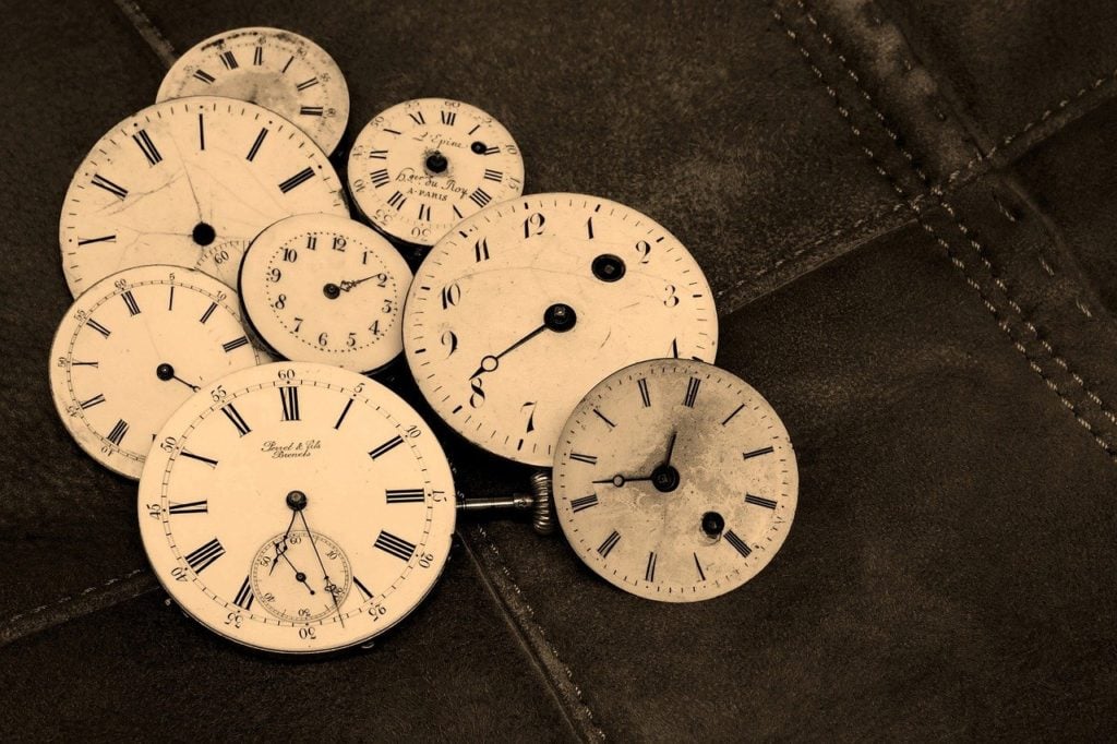 A pile of old clock faces