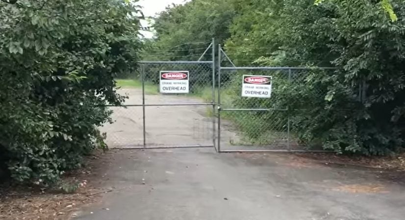 A fence with a DANGER sign on it, leading to the Street With No Name