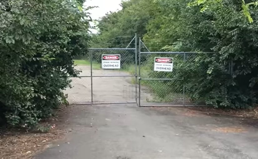 A fence with a DANGER sign on it, leading to the Street With No Name