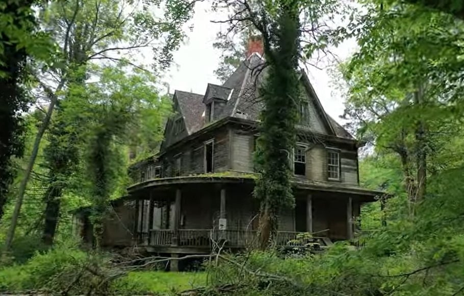 The exterior of Winderbourne mansion, viewed through trees