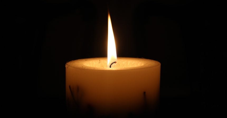A lit candle in the dark
