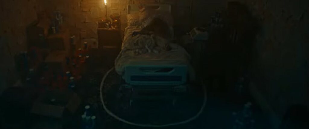 A still from salt showing a small child in a bed with a circle of salt on the floor around it