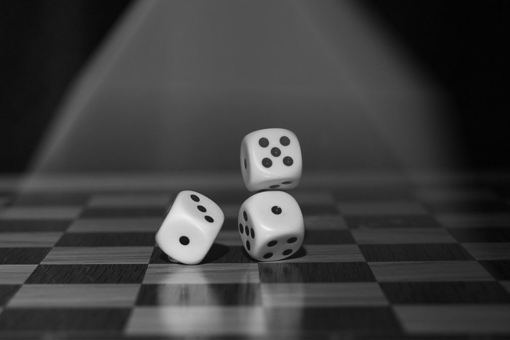 Three dice on a black and white checkered floor