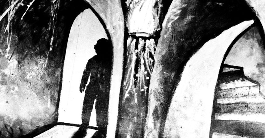 A black and white illustration of a shadowy, humanoid figure in a dark room