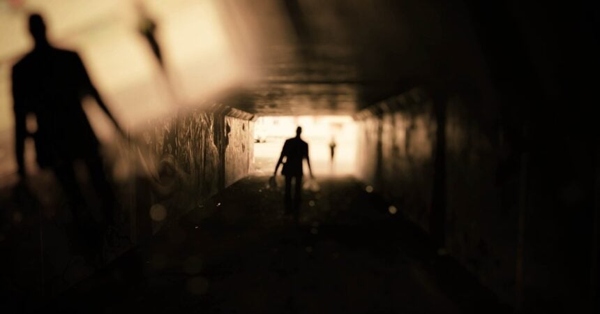 A human shadow at the end of a long, dark tunnel