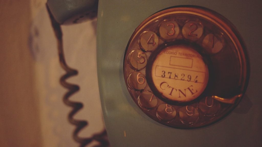 A close-up of the dial on a rotary phone