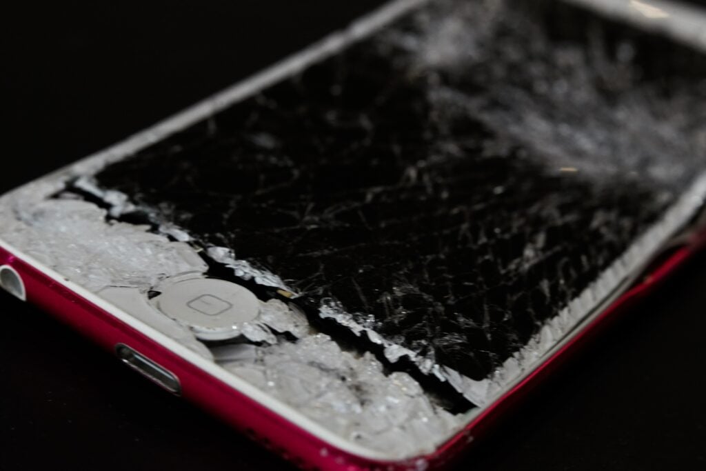 A broken iPhone with a smashed screen