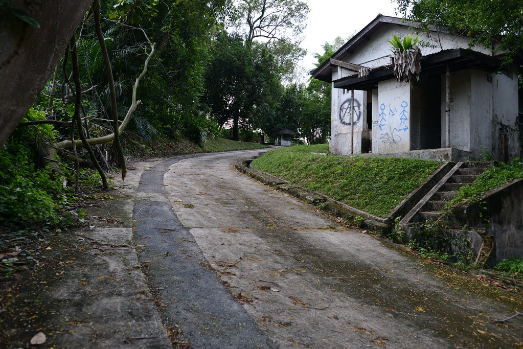 A road and an abandoned building at the old hostel