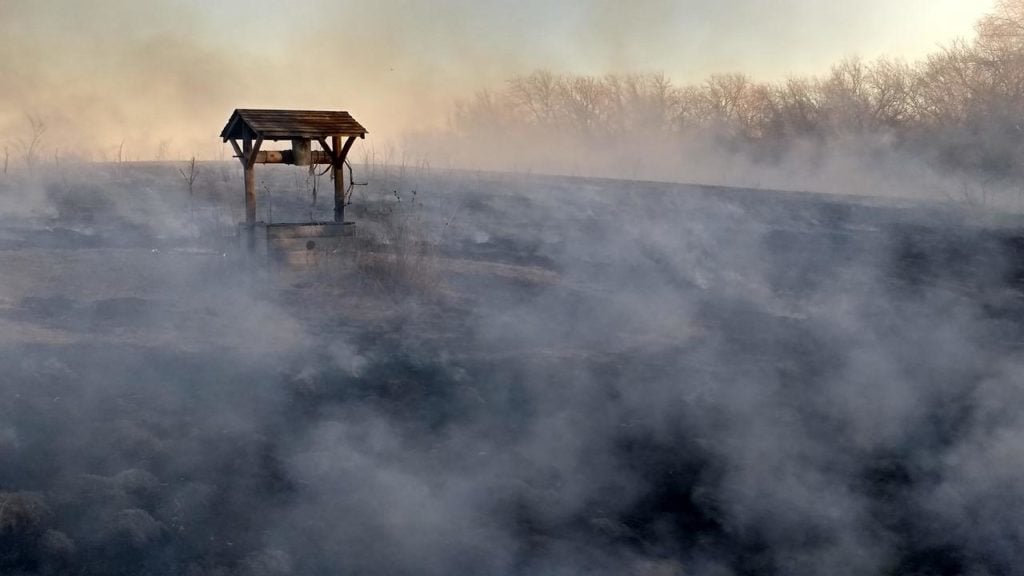 an old wishing well in a foggy field