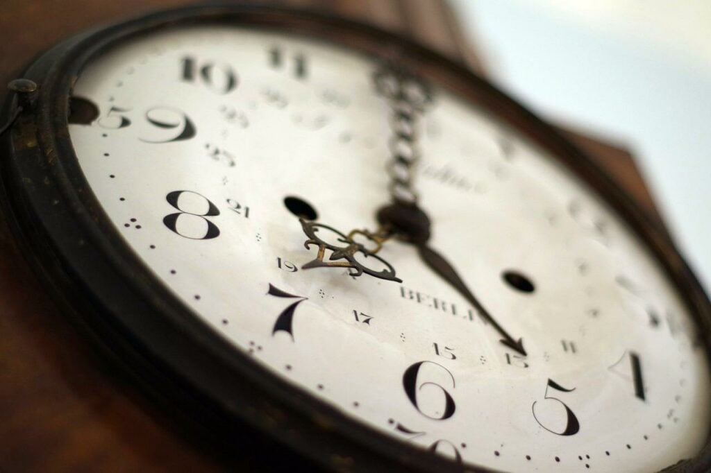 A close-up of an old analog clock face