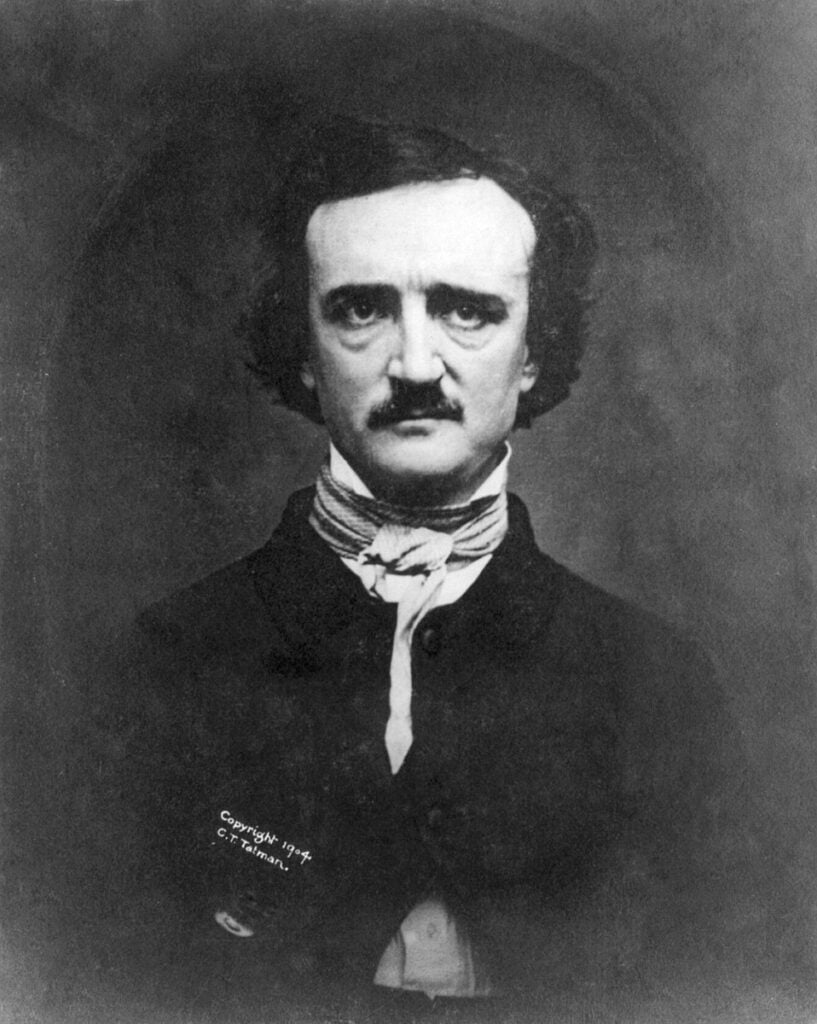 A portrait of Edgar Allan Poe, a dour-looking white man with dark hair, prominent eyebrows, and a moustache. HE is wearing a dark coat and a white cravat