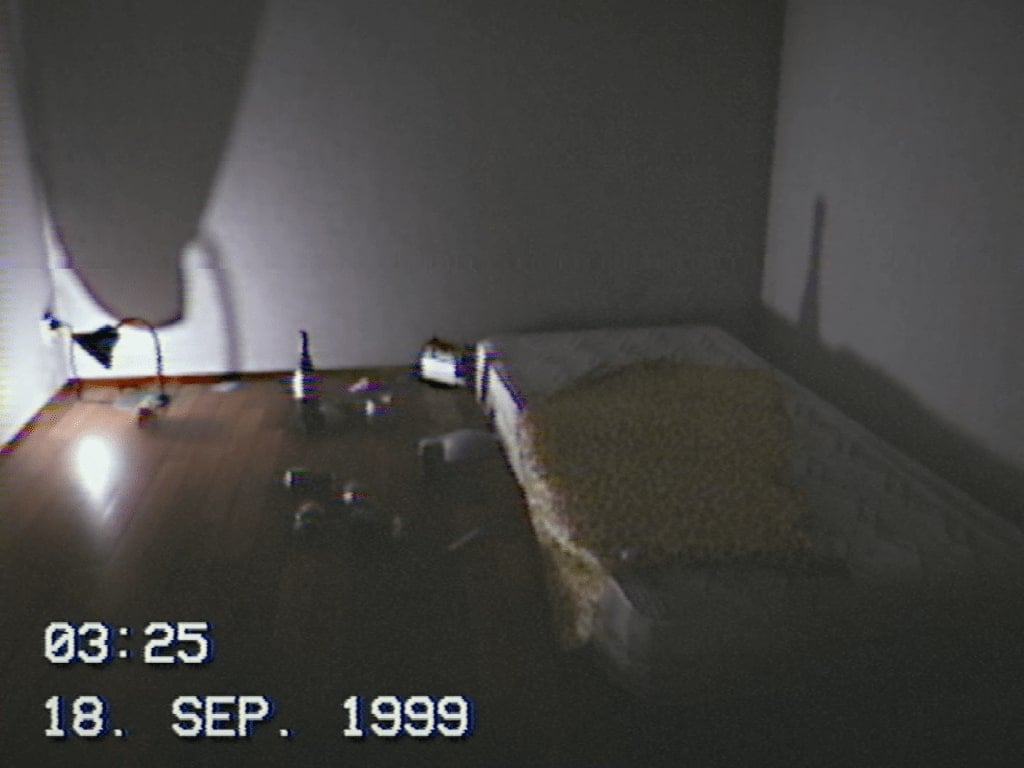 A screenshot from September 1999 showing a mattress on a bare floor with a small lamp and bottles strewn about.