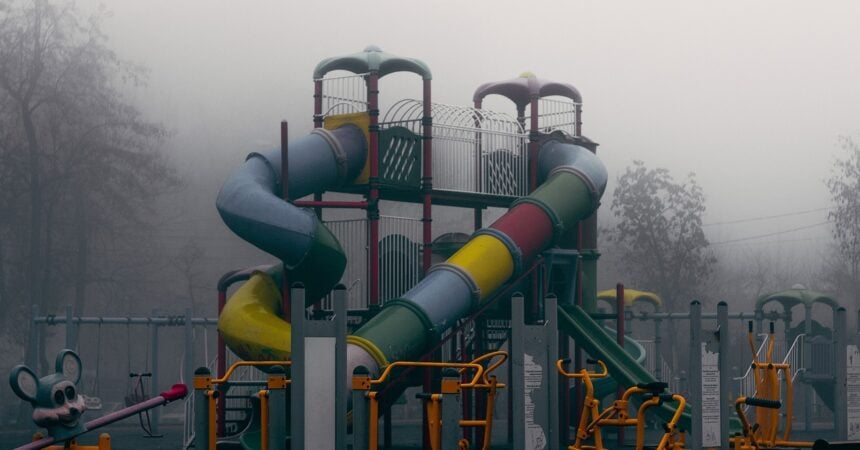 A playground slide, looking mysterious in the mist