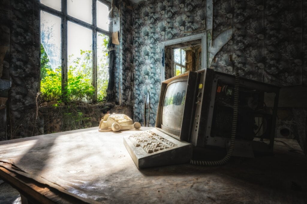 an old, abandoned computer inside a room in an old, abandoned house