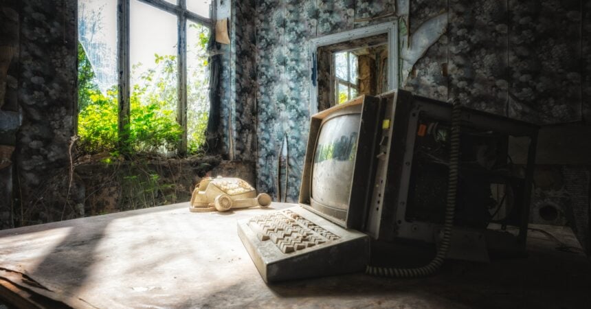 an old, abandoned computer inside a room in an old, abandoned house