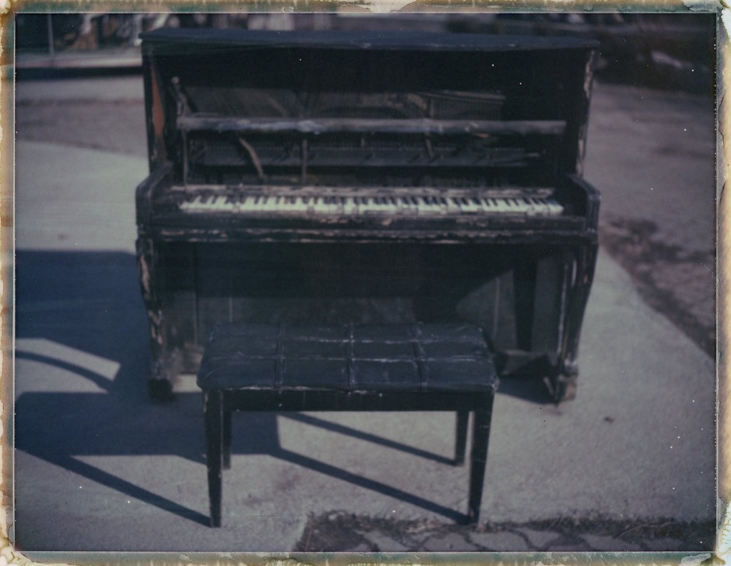 A beat-up upright piano on the grounds of Yongma Land