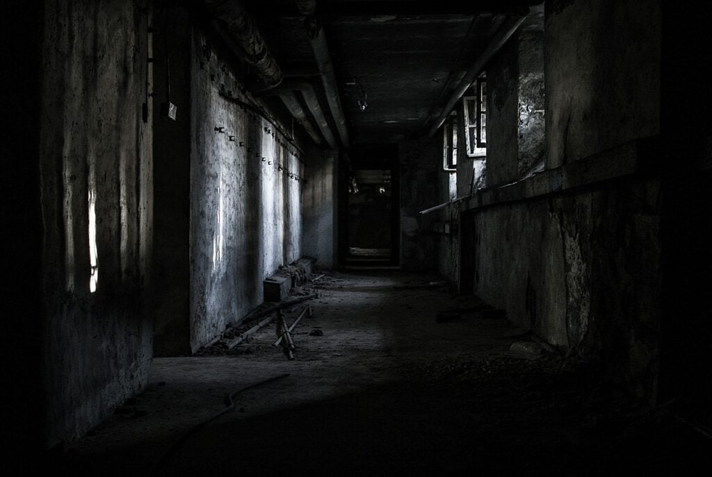 A crumbling hallway in an abandoned building