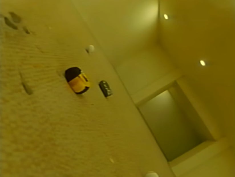 a slanted POV from the floor of a yellow room, as if the viewer has just fallen to the ground