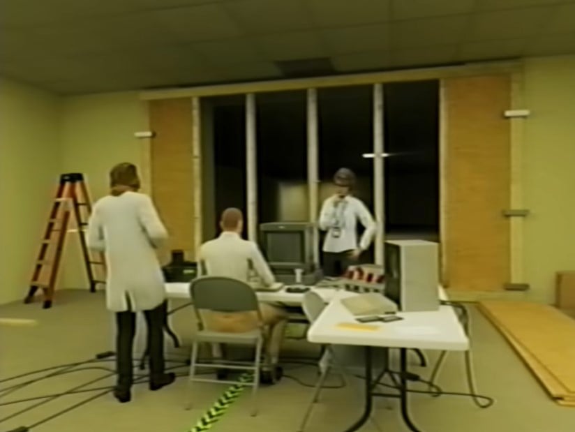 A team of white-coated scientists at a command table with computers in the Backrooms