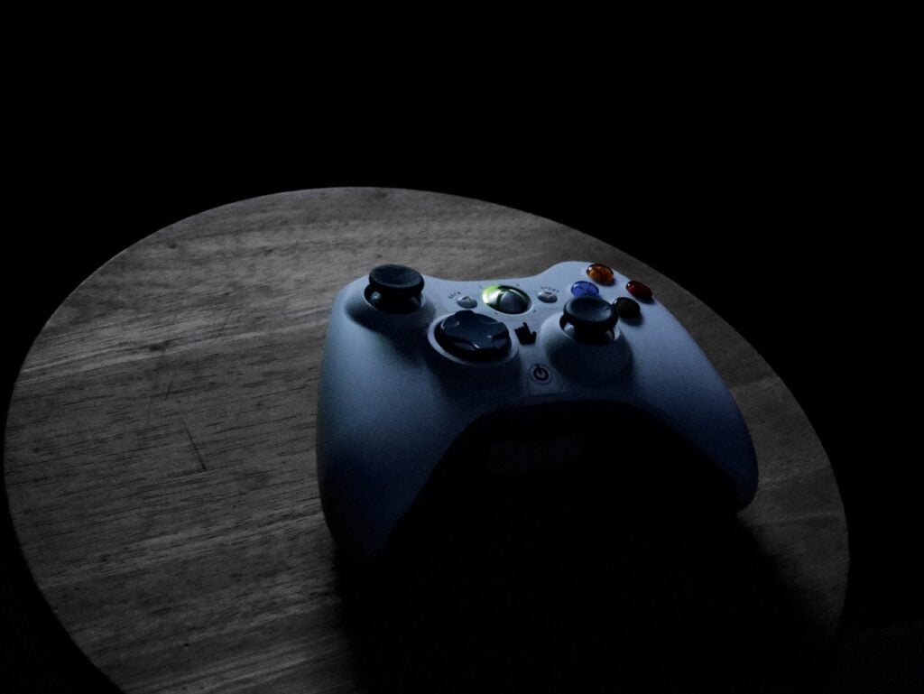 An Xbox controller on a wood surface