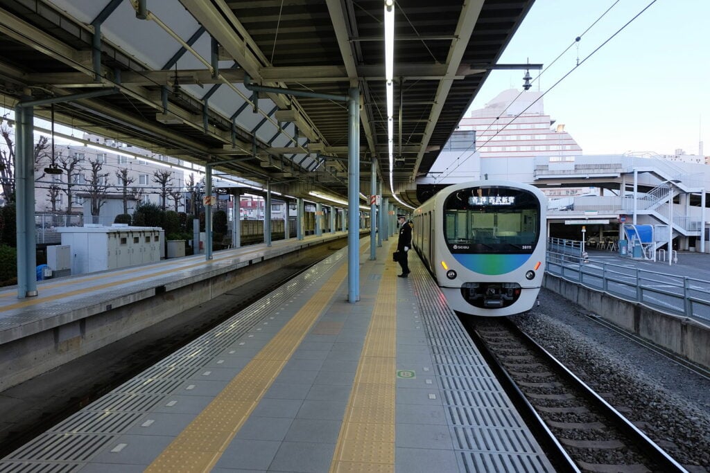 The platform at Hon-Kawagoe Station in Japan with a train waiting to leave