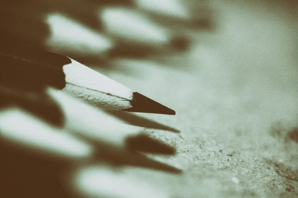 a black and white photo of sharpened wood pencil tips