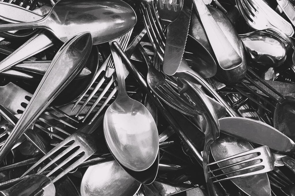 a jumbled pile of cutlery and silverware