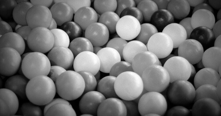 a black and white photo of plastic balls in a ball pit