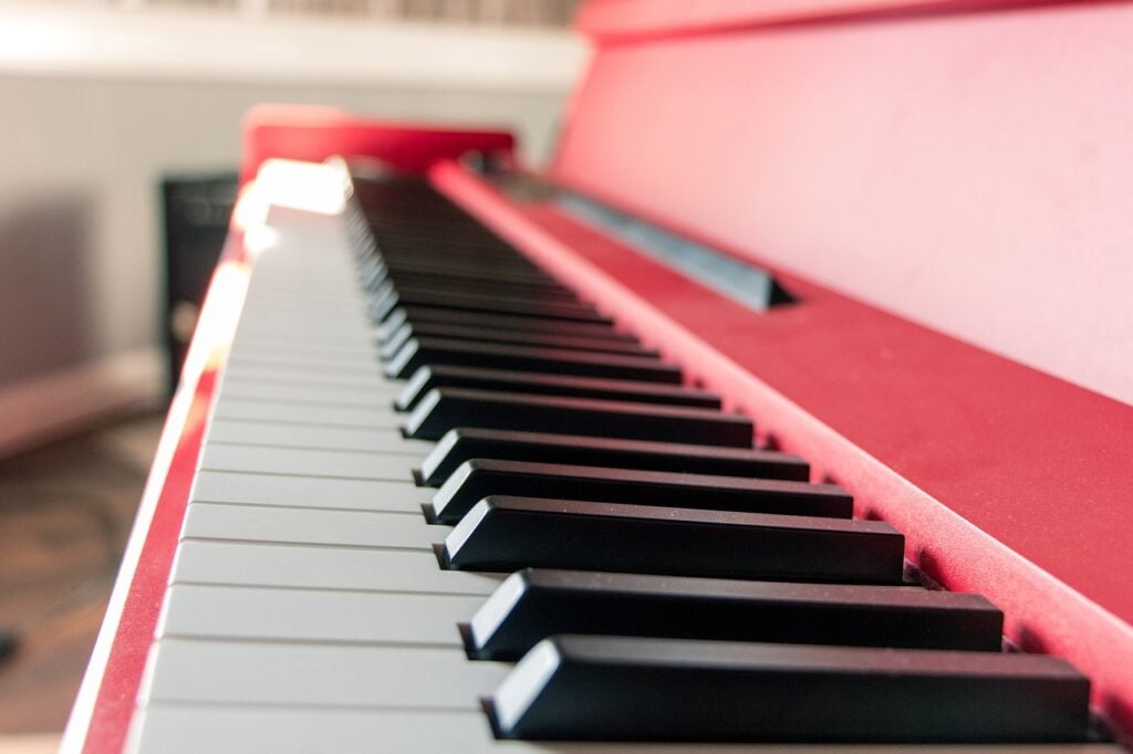 the keyboard of a red piano