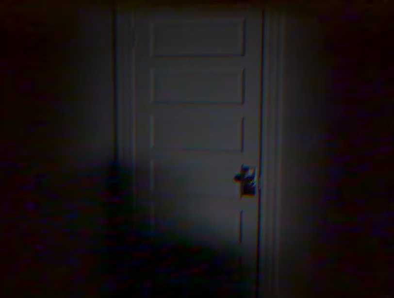 A screenshot from the web series DOORS depicting a white door that should not exist