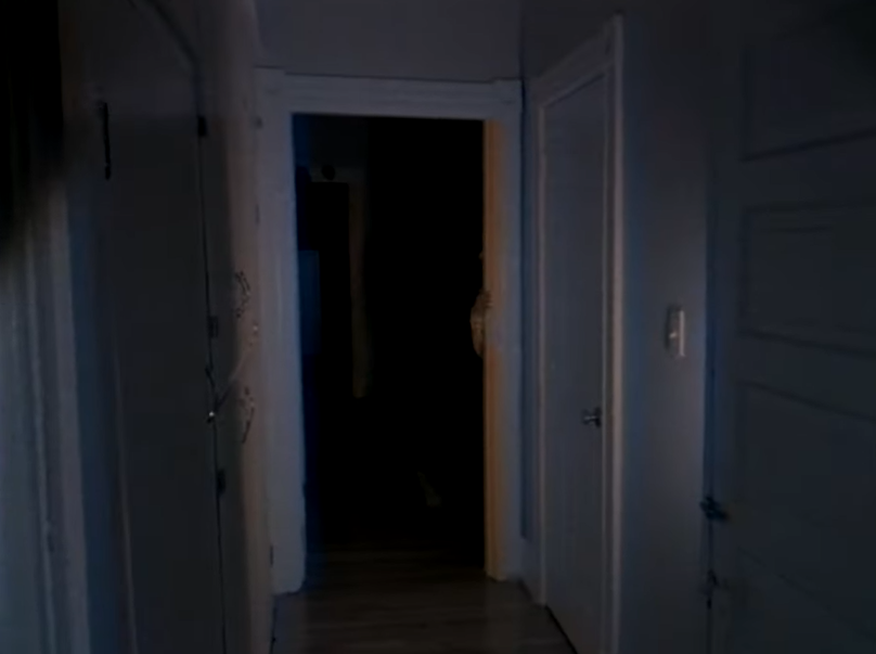 A screenshot from the second DOORS video depicting an open door frame with a single hand visible through it
