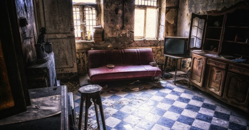 an abandoned, decaying living room, with a red sofa, an old television, and a stool on a checker-printed floor. sunlight comes in through two windows, highlighting the dust and cobwebs