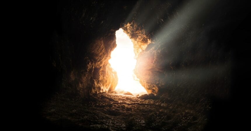 an opening in a cave. sunlight streams in from the outside