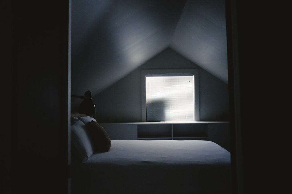 a modern bedroom, dark and a little bit spooky