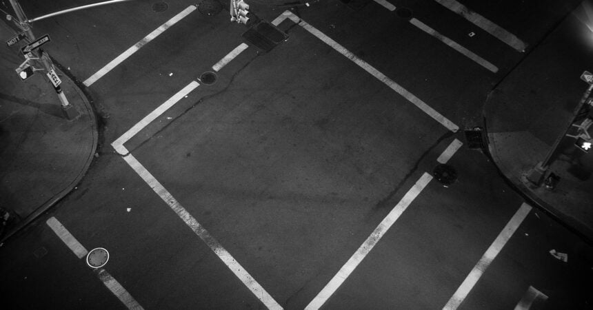 aerial view of a four-way crosswalk at the intersection of two roads