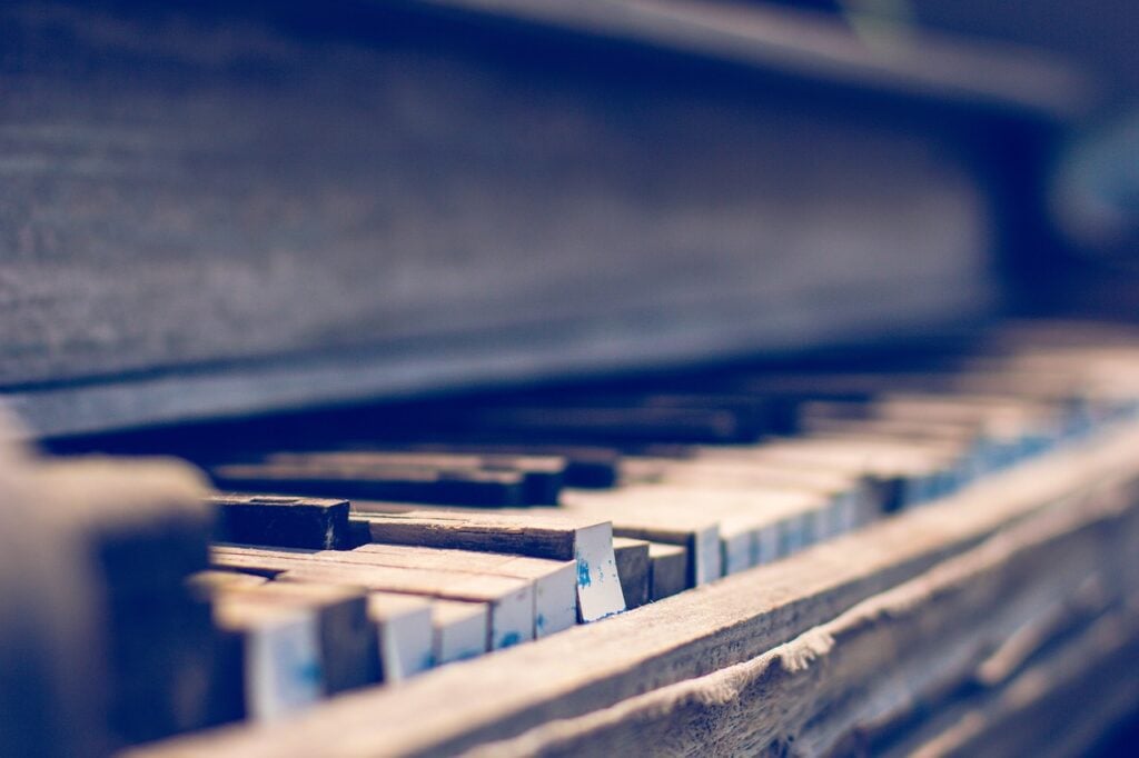 side view of a piano keyboard, its keys somewhat destroyed