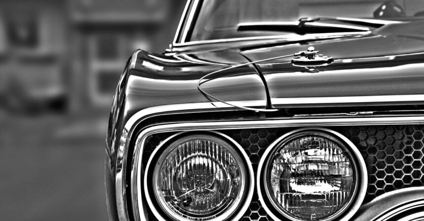 black and white close-up shot of headlights on a car