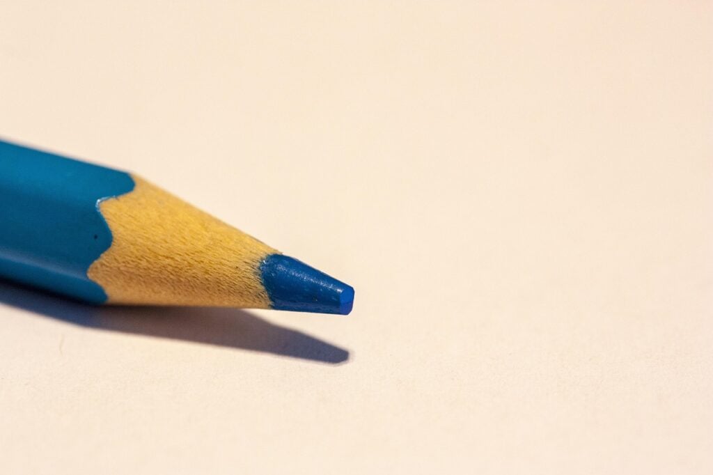 a closeup of the point of a blue colored pencil