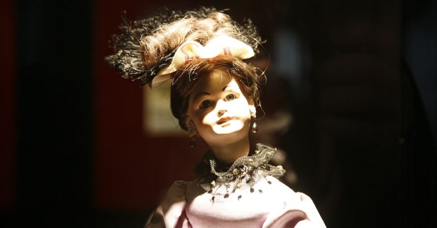 a female-presenting automaton wearing a fancy hat and dress. the uncanny valley is strong here.