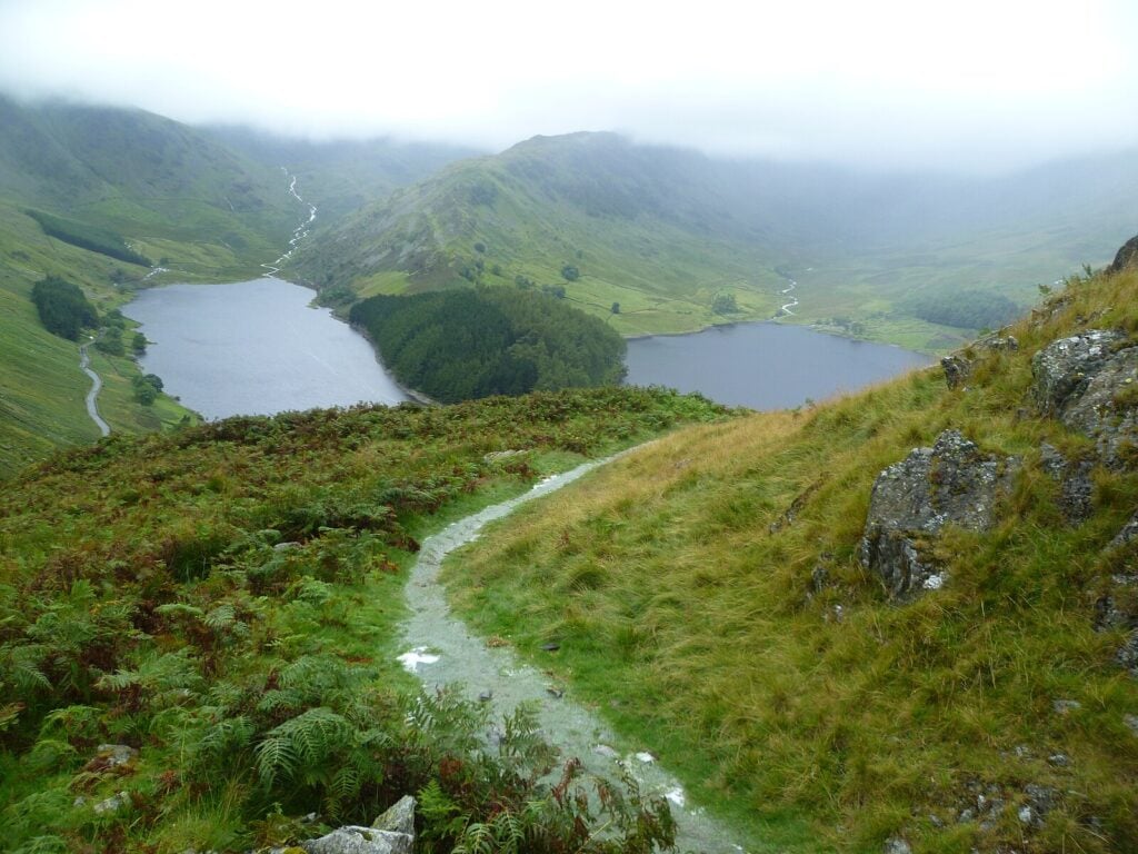a corpse road - a worn footpath leading through green hills in the UK, once used to carry the dead to their final resting place