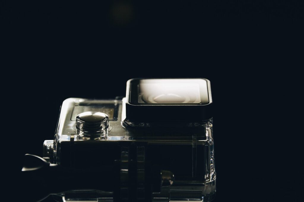 a video camera against a black background, shot dramatically from below