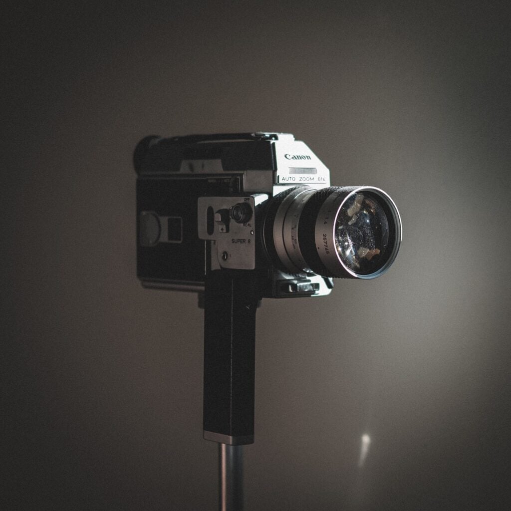 a video camera on a tripod, recording
