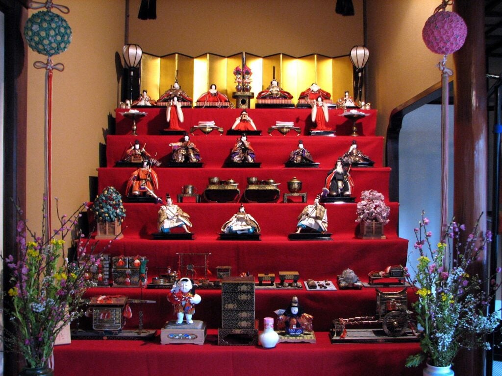 a hina doll setup, with many red platforms lined with many hina dolls